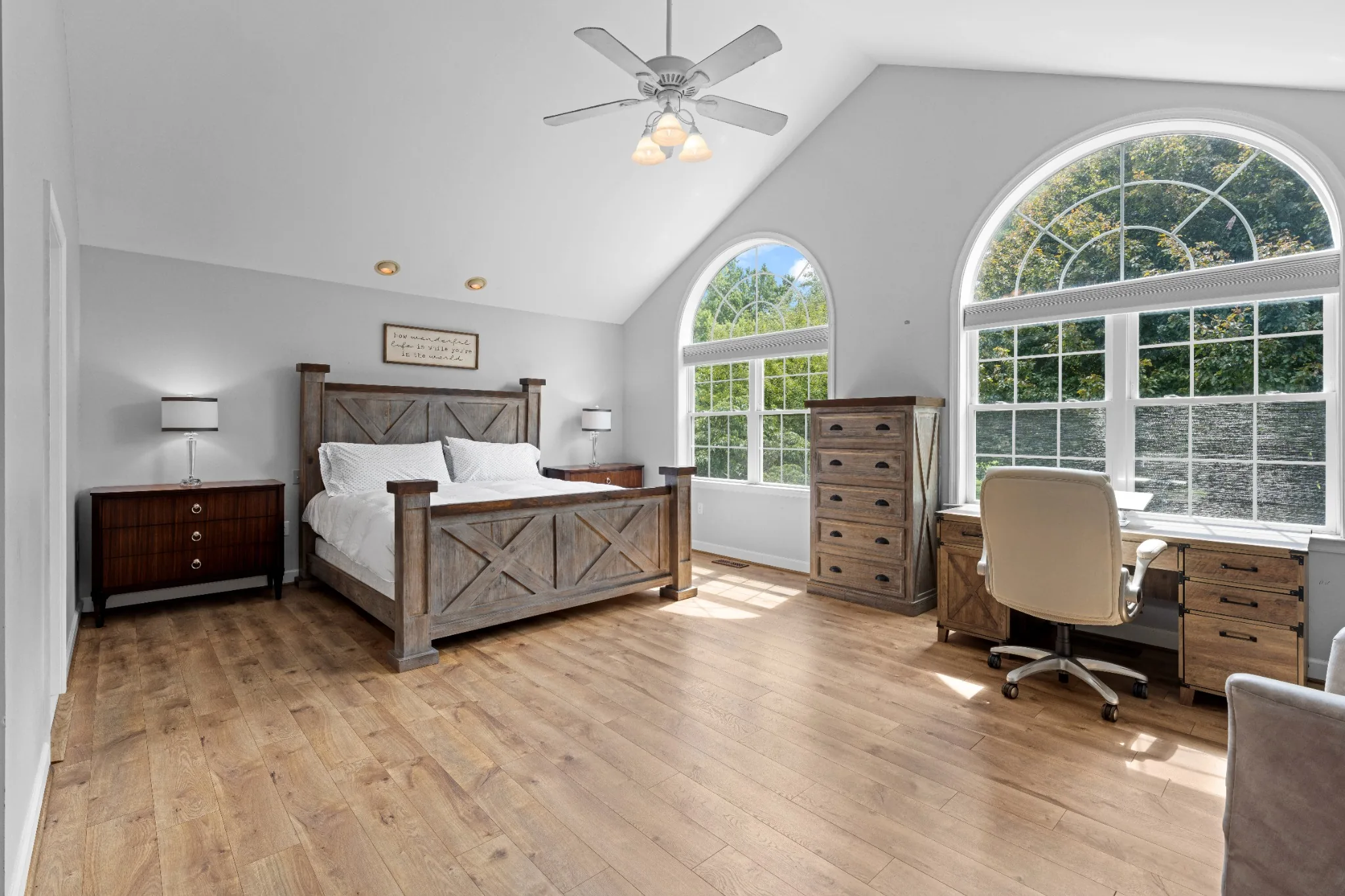 Sunlit bedroom with tall arched windows